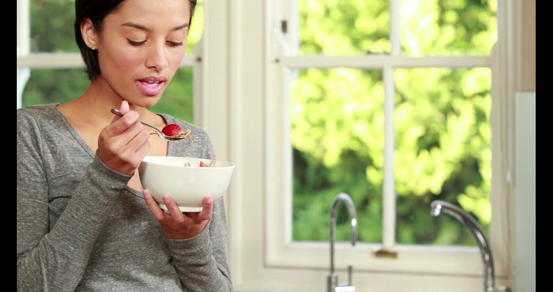 Young Woman Enjoying Breakfast in Bright Kitchen - Free Images, Stock Photos and Pictures on Pikwizard.com