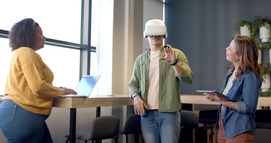 Diverse team testing virtual reality headset while collaborating around modern high table