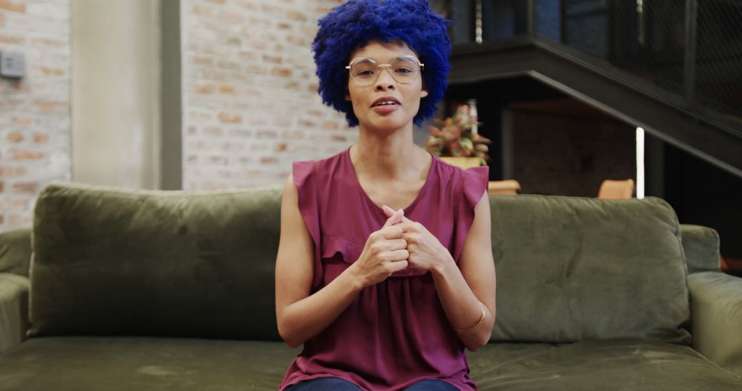 Casual Businesswoman with Blue Afro Having Video Call