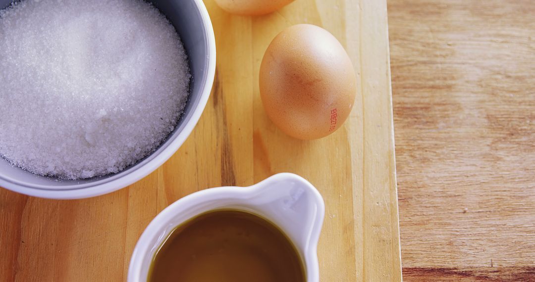 Baking Ingredients with Eggs, Sugar, and Oil on Wooden Surface - Free Images, Stock Photos and Pictures on Pikwizard.com