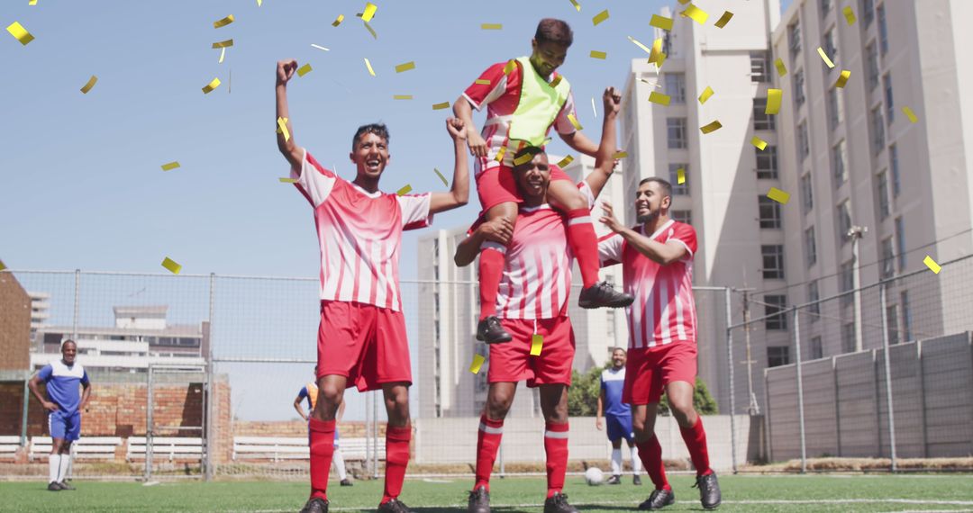 Victorious football team celebrating under falling confetti