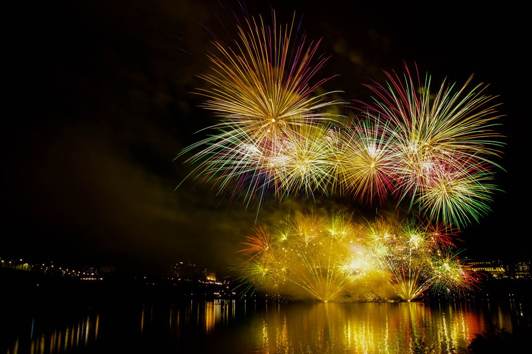 Vibrant Fireworks Display Over Waterfront at Night