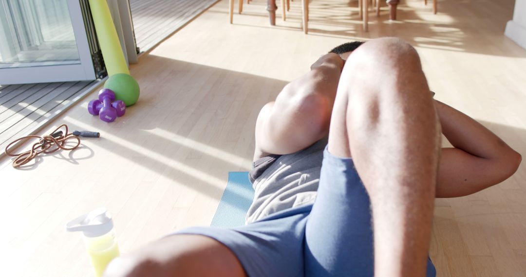 Man Exercising Indoors Doing Crunches - Free Images, Stock Photos and Pictures on Pikwizard.com