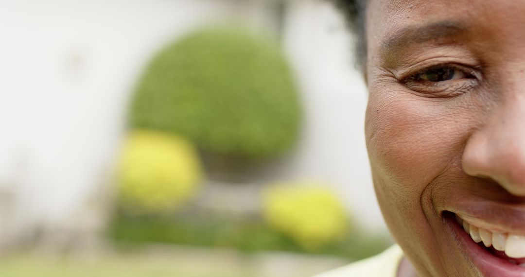 Close-Up Happy African American Woman's Face Smiling with Garden in Background - Free Images, Stock Photos and Pictures on Pikwizard.com