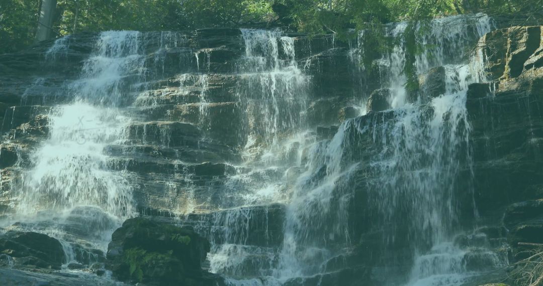 Majestic Cascading Waterfall with Mossy Stones in Forest Gorge