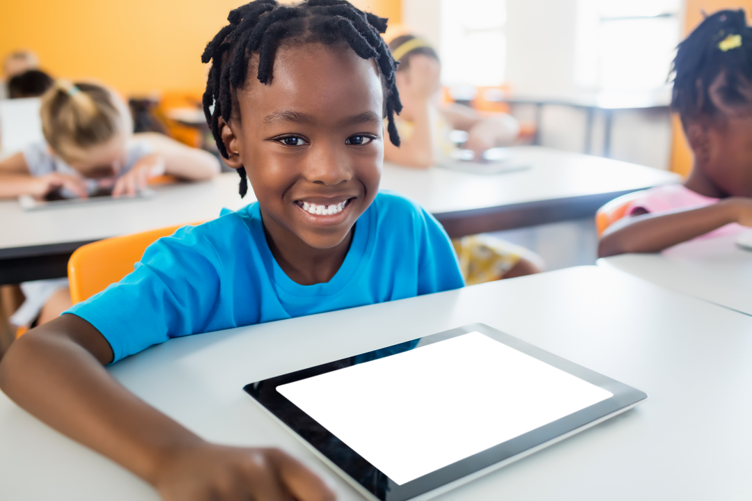 Smiling African American Boy Using Transparent Tablet in Classroom - Download Free Stock Images Pikwizard.com