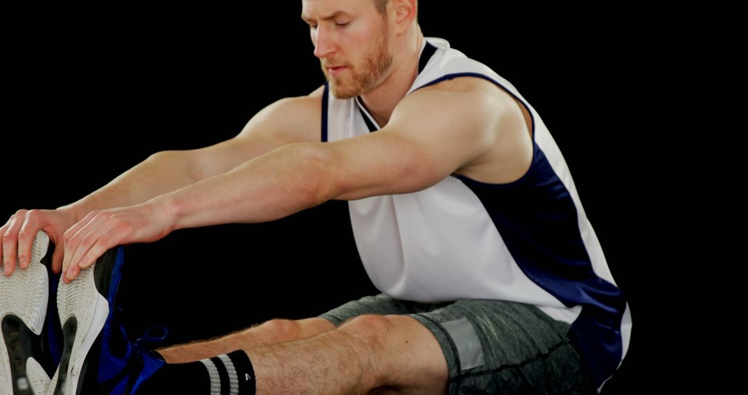 Young Athletic Man Stretching Ahead of Workout in Sports Attire - Free Images, Stock Photos and Pictures on Pikwizard.com