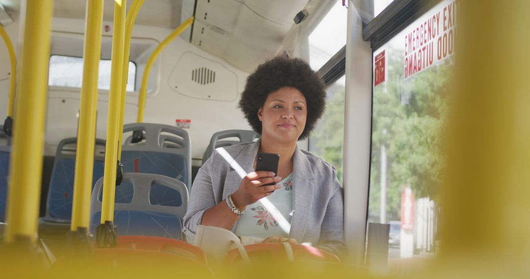 Happy Woman Using Smartphone on Public Bus Commute