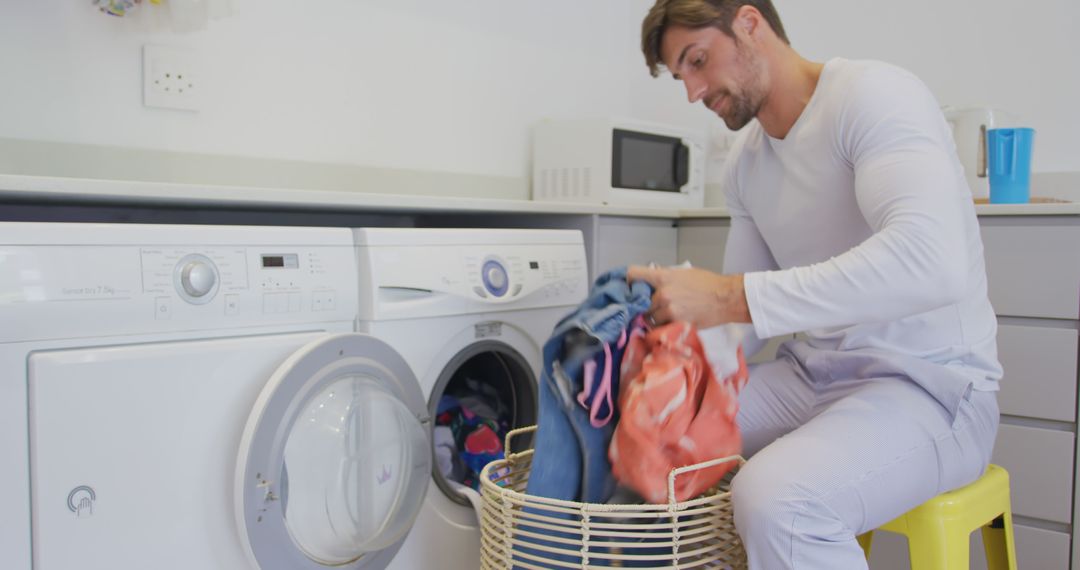 Man Doing Laundry at Home in Modern Laundry Room - Free Images, Stock Photos and Pictures on Pikwizard.com