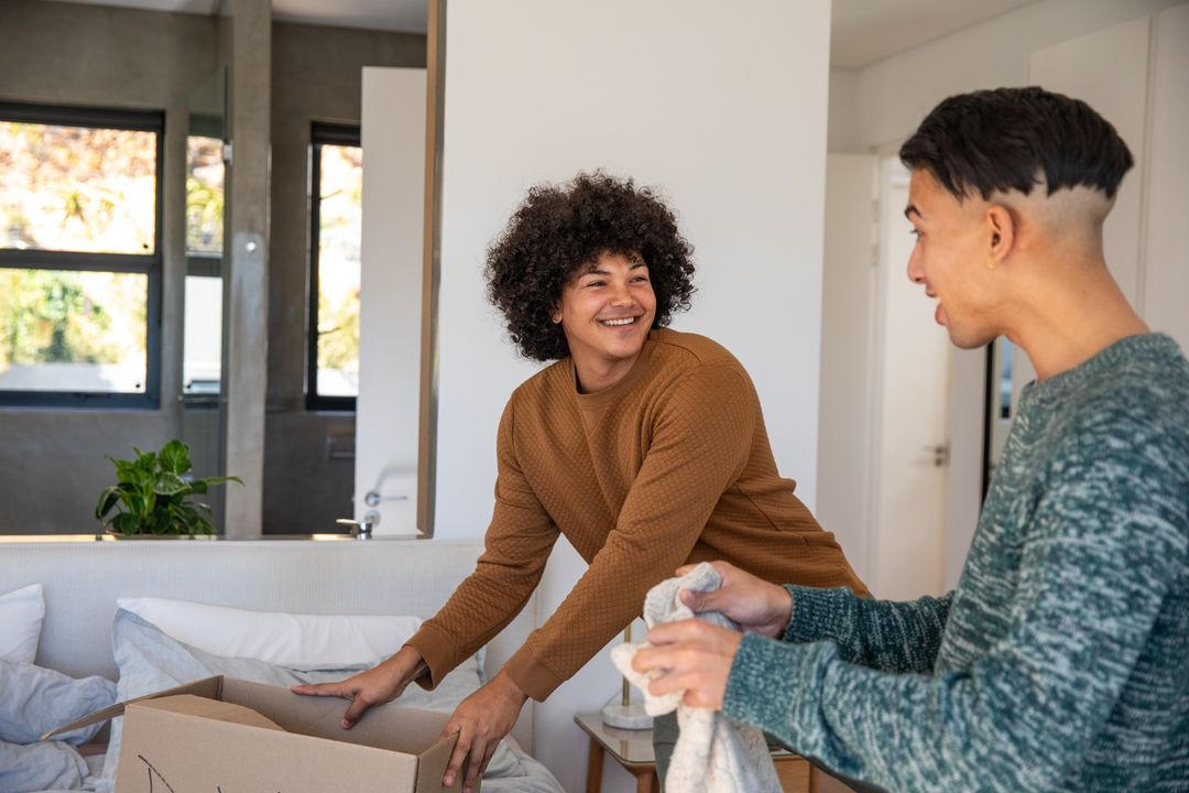 Diverse Friends Unpacking and Enjoying New Home Together