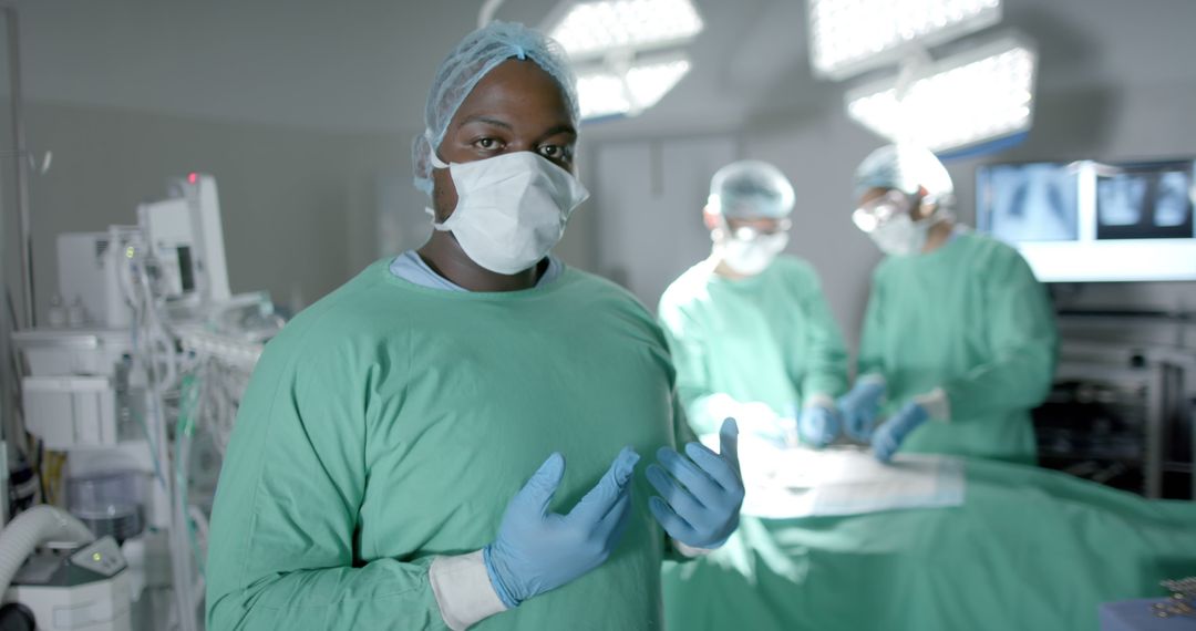 Confident Surgeon in Operating Room with Team During Surgery - Free Images, Stock Photos and Pictures on Pikwizard.com