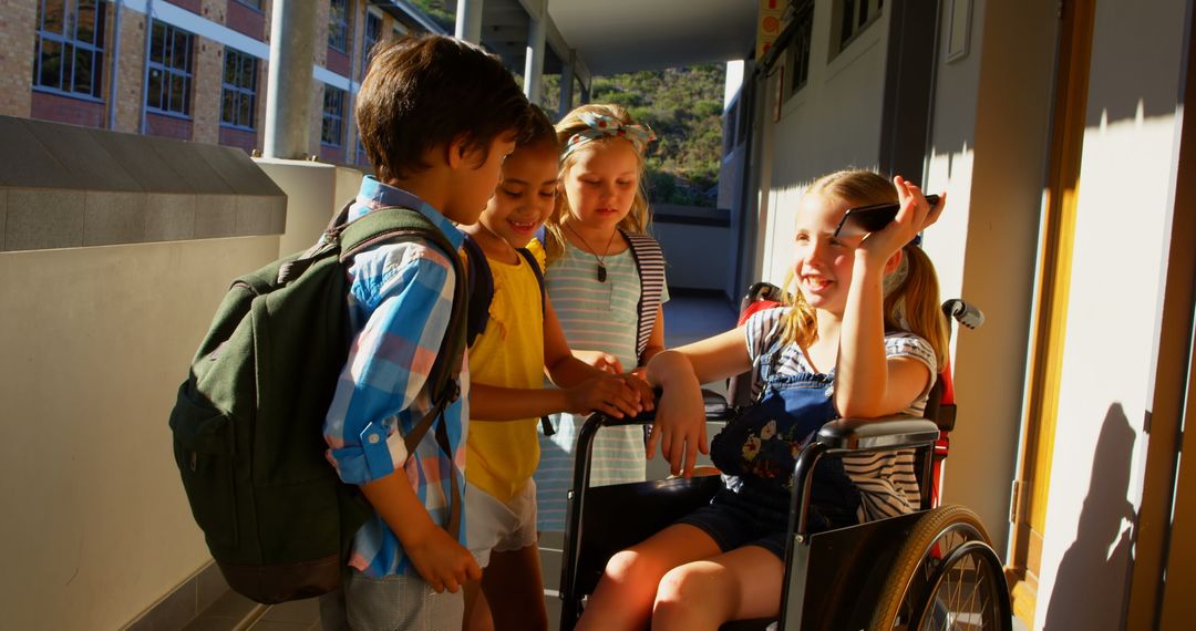 Diverse Schoolchildren Interacting with Wheelchair User in Corridor