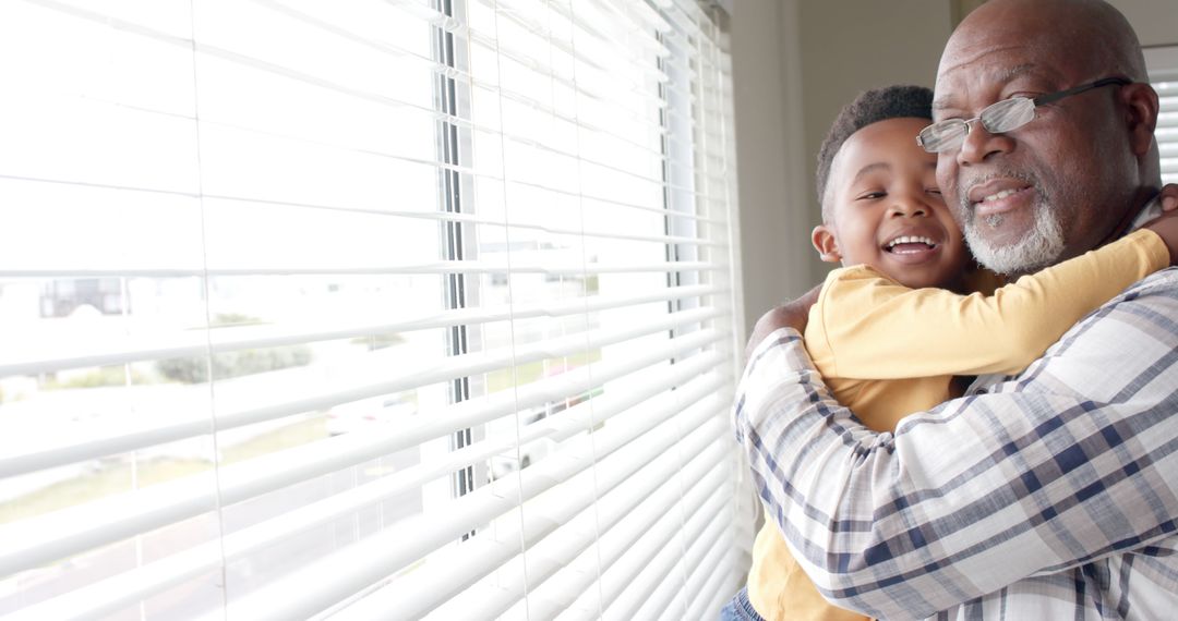 Grandfather Hugging Grandson by Window - Free Images, Stock Photos and Pictures on Pikwizard.com