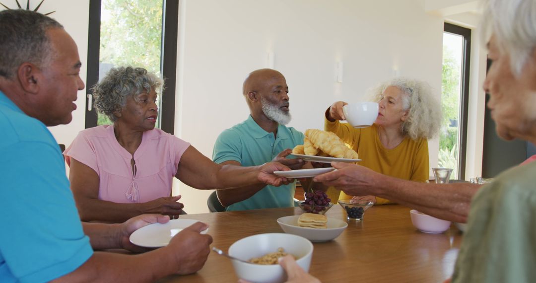 Senior Friends Enjoying Breakfast Together at Home - Free Images, Stock Photos and Pictures on Pikwizard.com