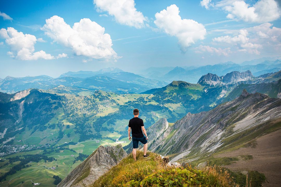 Man Enjoying Breathtaking Mountain View from Summit - Free Images, Stock Photos and Pictures on Pikwizard.com