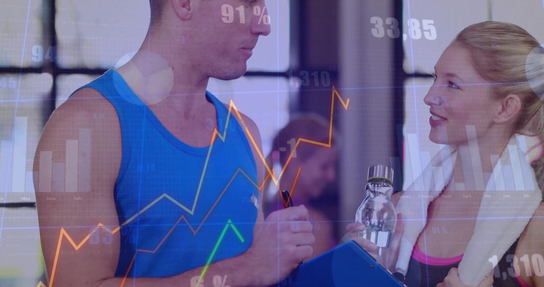 Trainer Discussing Fitness Goals with Client in Gym Environment