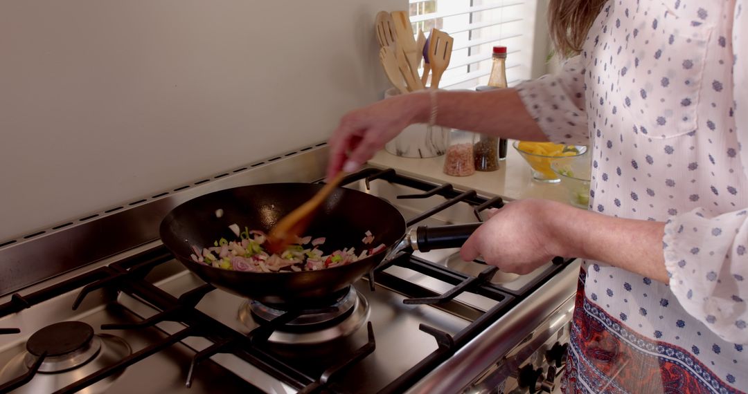 Rustic Homemaker Stirring Vegetables in Modern Kitchen Wok