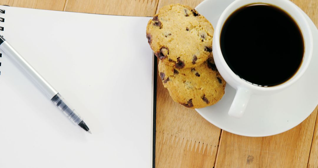 Pen, Notebook, Chocolate Chip Cookies and Coffee on Wooden Table - Free Images, Stock Photos and Pictures on Pikwizard.com