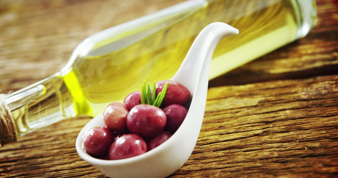 Fresh Olives in White Bowl with Olive Oil on Rustic Wooden Table - Free Images, Stock Photos and Pictures on Pikwizard.com