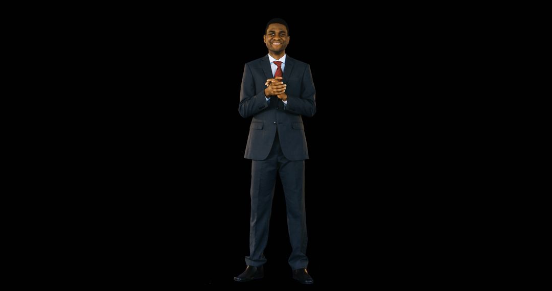 Confident Businessman Smiling in Dark Studio Background - Free Images, Stock Photos and Pictures on Pikwizard.com