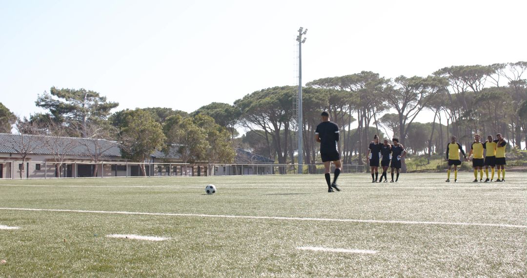 Soccer Team Practising Free Kick on Sunlit Field