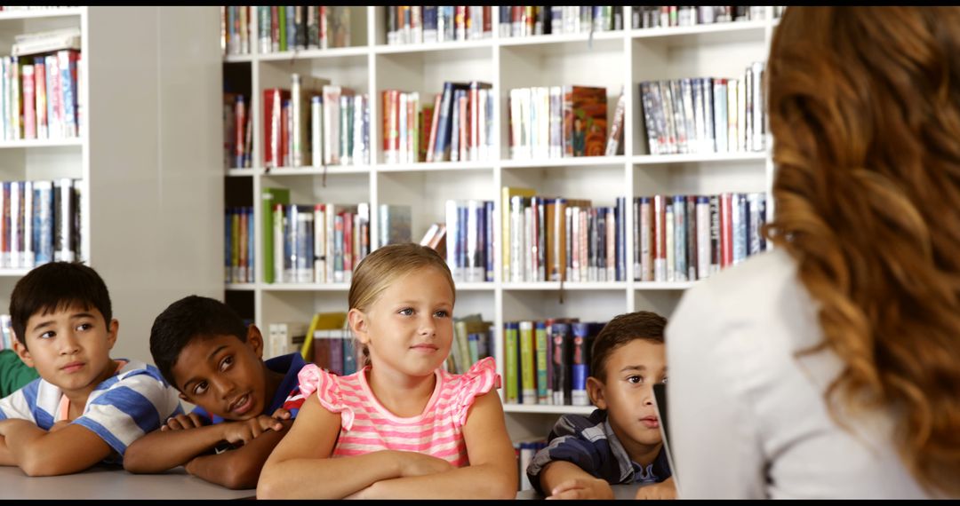 Teacher Reading Book to Attentive Elementary Students at Library - Free Images, Stock Photos and Pictures on Pikwizard.com