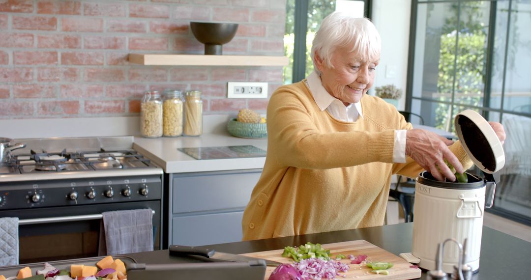 Senior Woman Composting Vegetable Peels in Modern Kitchen - Free Images, Stock Photos and Pictures on Pikwizard.com