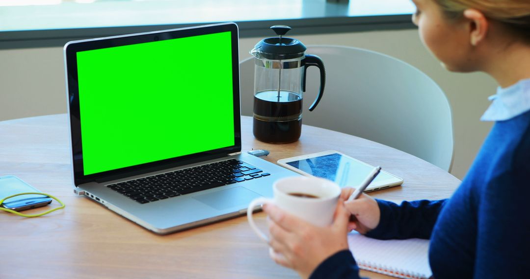 Woman Working at Desk on Laptop with Green Screen Display - Free Images, Stock Photos and Pictures on Pikwizard.com