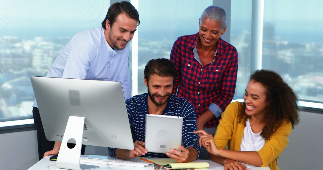 Diverse team collaborating in modern office with tablet and desktop - Free Images, Stock Photos and Pictures on Pikwizard.com