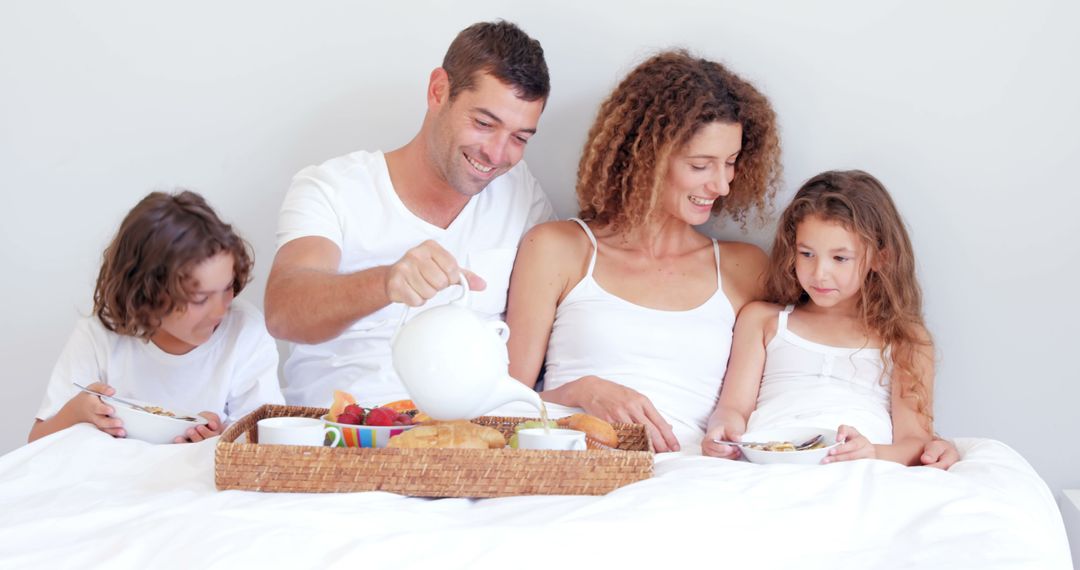 Family Enjoying Breakfast Together in Bed - Free Images, Stock Photos and Pictures on Pikwizard.com