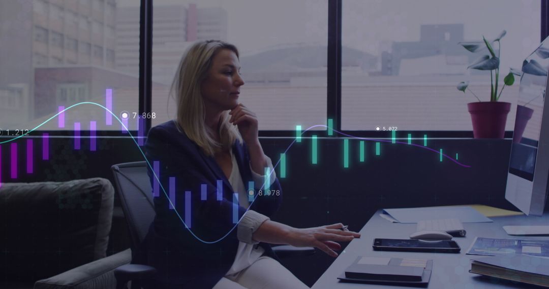 Businesswoman Analyzing Financial Data on Computer at Office Desk