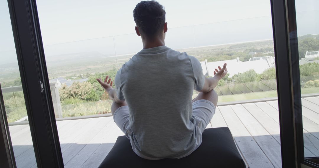 Man Practicing Meditation on Balcony with Scenic View - Free Images, Stock Photos and Pictures on Pikwizard.com