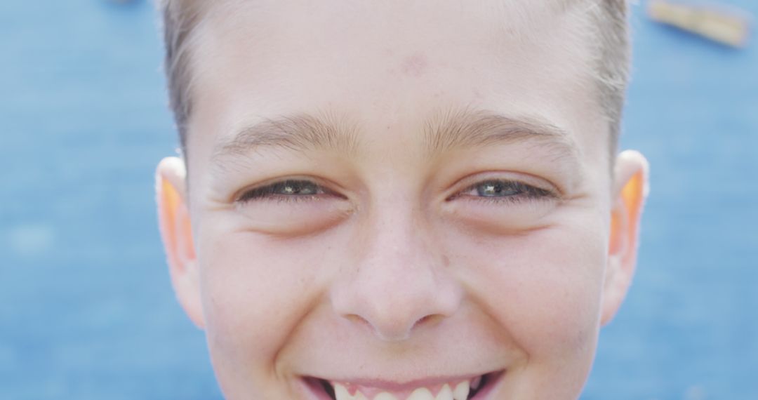 Close-Up of Smiling Boy with Blue Background - Free Images, Stock Photos and Pictures on Pikwizard.com