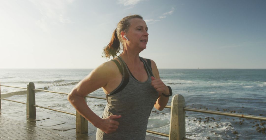 Senior Woman Running on Seaside Promenade at Sunrise - Free Images, Stock Photos and Pictures on Pikwizard.com