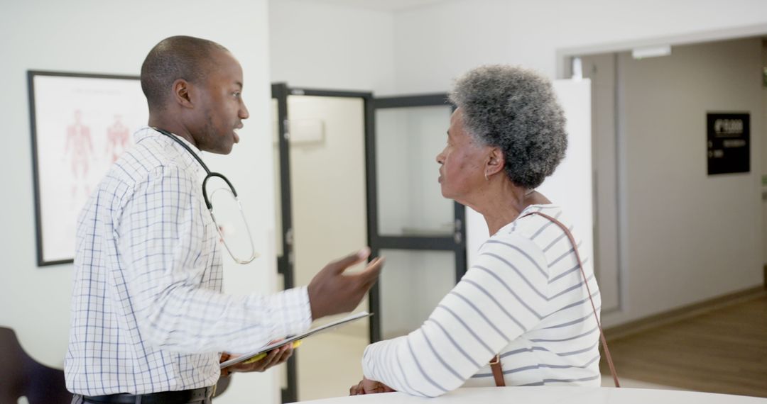 Doctor Consulting with Senior Patient at Clinic Reception - Free Images, Stock Photos and Pictures on Pikwizard.com