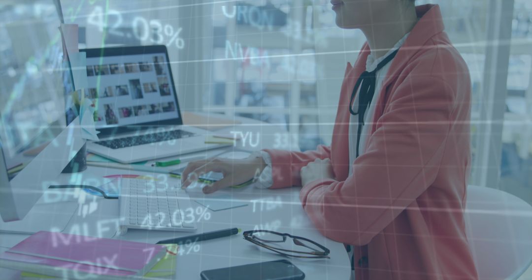 Businesswoman Analyzing Financial Data on Computer in Office