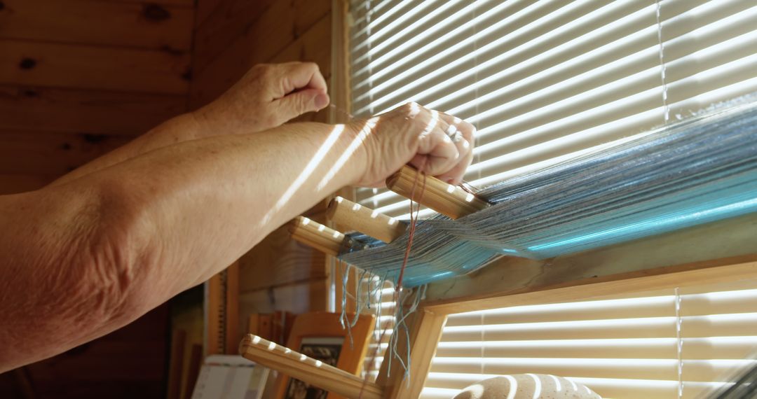 Elderly Woman Weaving on Inkle Loom by Sunny Window