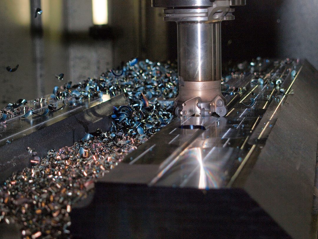Close-up of CNC Milling Machine Amidst Metal Work shavings