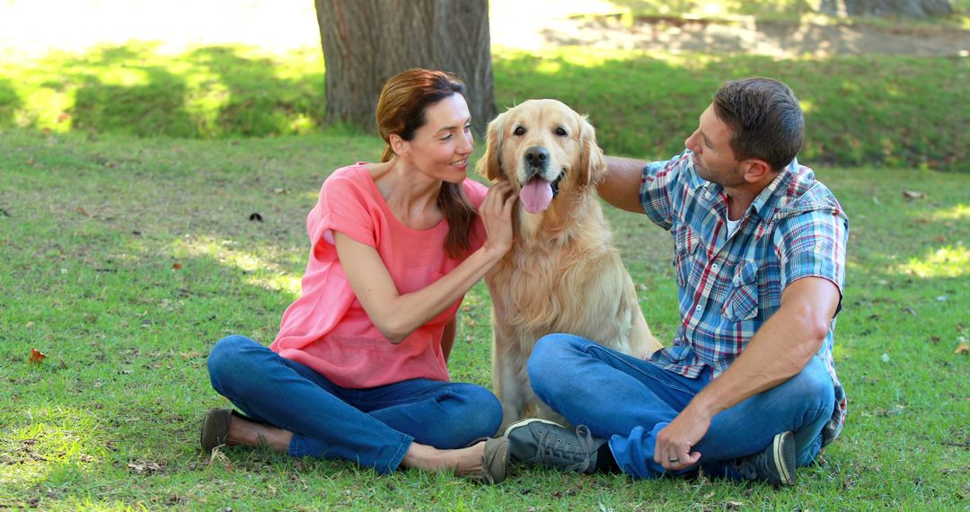 Happy Couple Relaxing Outdoors with Golden Retriever Dog - Free Images, Stock Photos and Pictures on Pikwizard.com