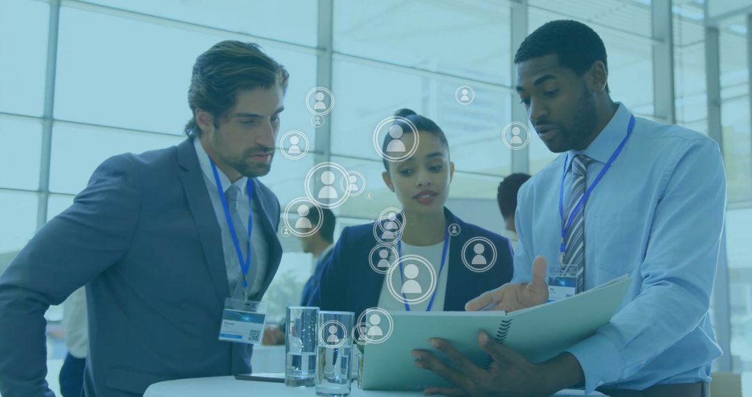 Diverse Business Team Analyzing Data in Office with Global Icons Overlay