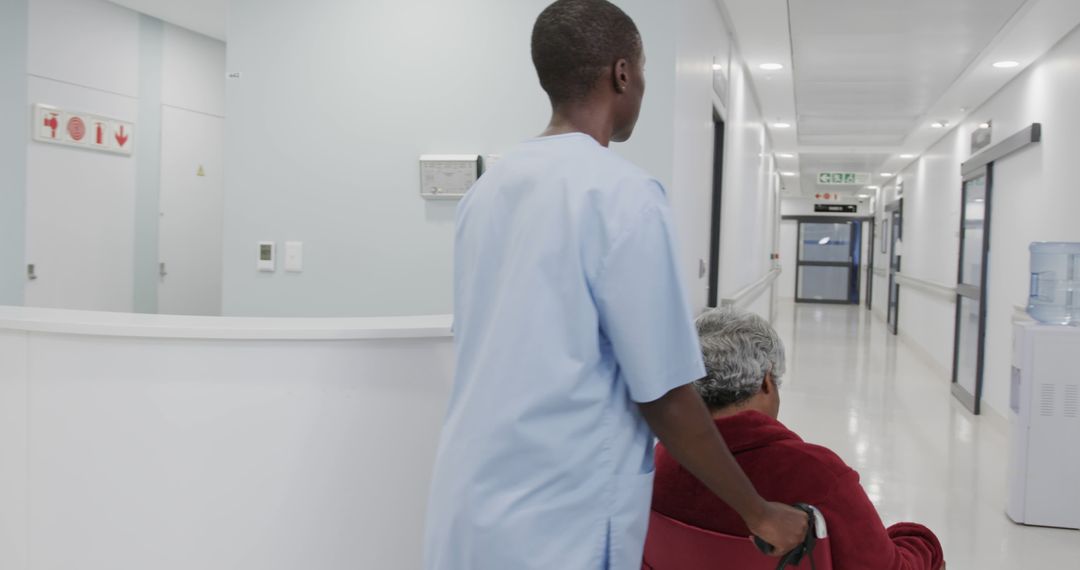 Nurse Assisting Senior Patient in Hospital Corridor - Free Images, Stock Photos and Pictures on Pikwizard.com