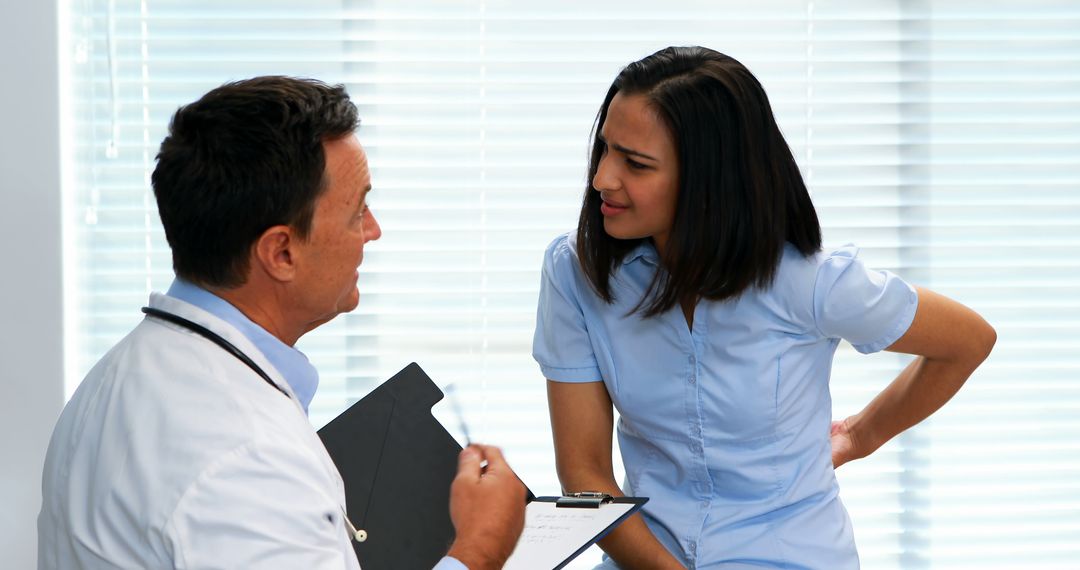 Doctor Consulting Concerned Patient in Office - Free Images, Stock Photos and Pictures on Pikwizard.com