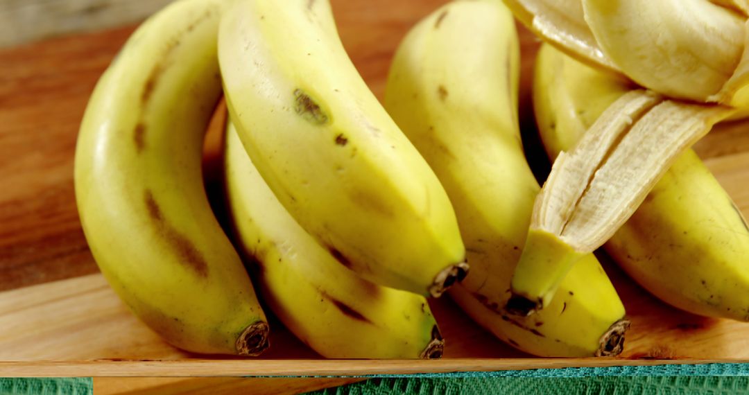 Close-up of Fresh Ripe Bananas on Wooden Surface - Free Images, Stock Photos and Pictures on Pikwizard.com