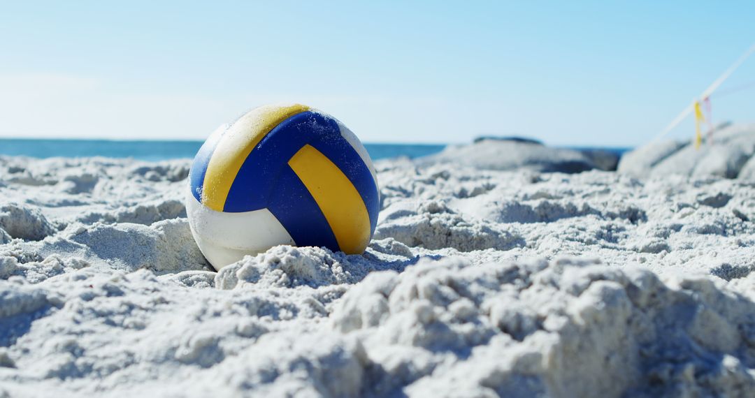 Volleyball Lying on Sandy Beach under Clear Blue Sky - Free Images, Stock Photos and Pictures on Pikwizard.com