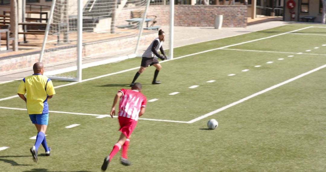 Youth Soccer Players Competing on Field in Sunny Game Day