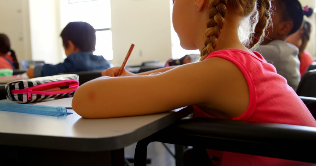 Elementary School Child Writing in Classroom