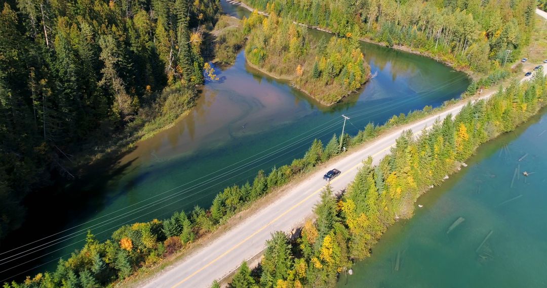 Scenic Aerial View of Country Road by River in Autumn Forest - Free Images, Stock Photos and Pictures on Pikwizard.com