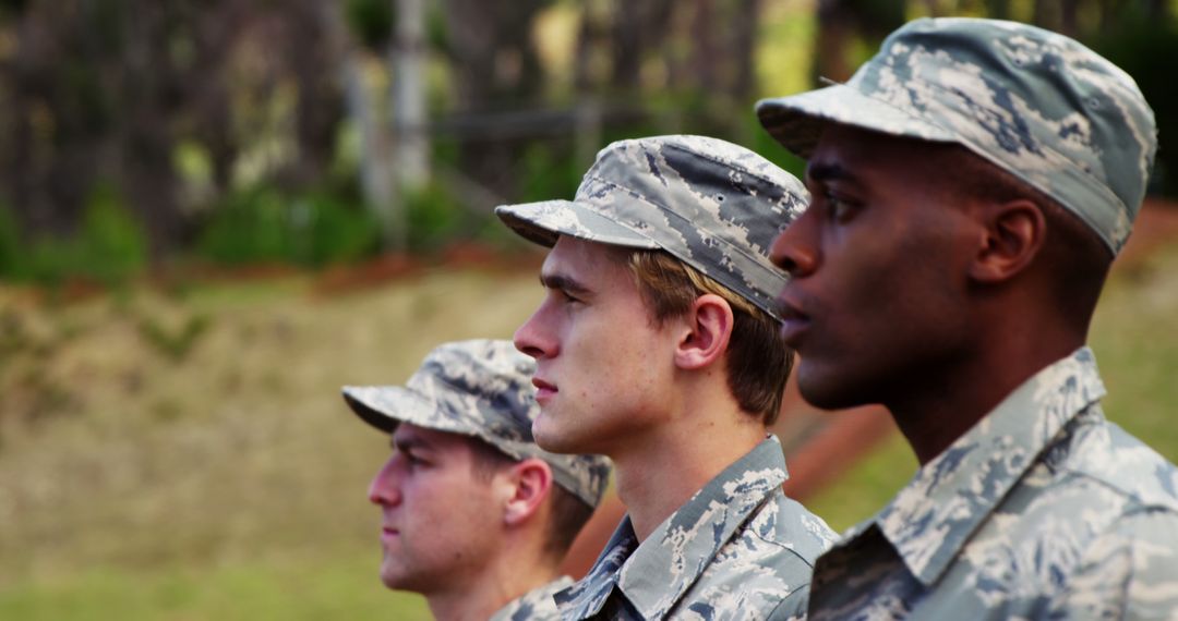 Disciplined Soldiers in Camouflage Uniforms Standing at Attention