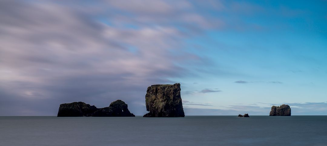 Seaside Rock Formations Under Blue Sky at Dawn - Free Images, Stock Photos and Pictures on Pikwizard.com