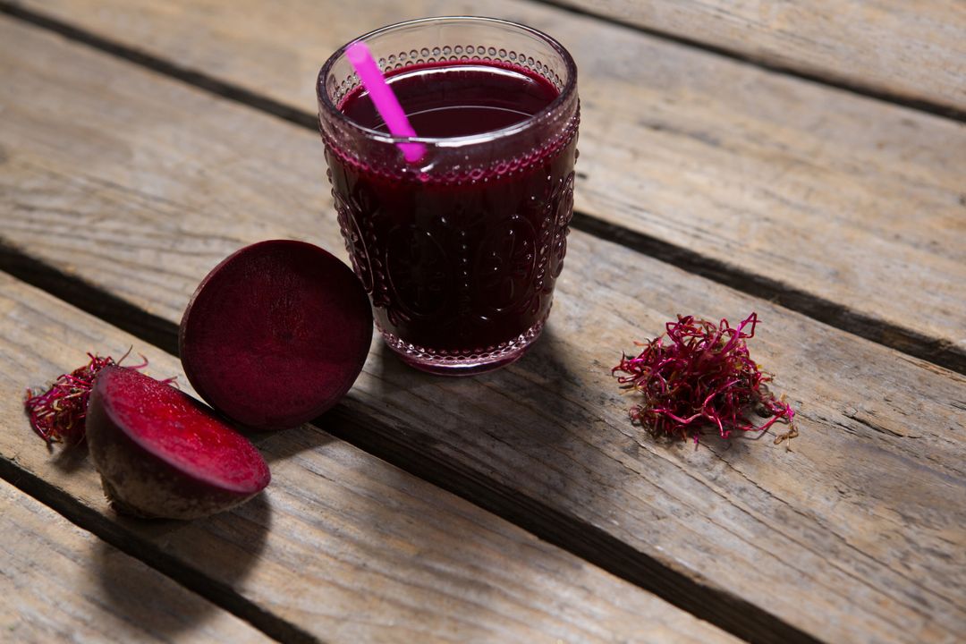Beetroot juice and slice of beetroot on wooden table - Free Images, Stock Photos and Pictures on Pikwizard.com
